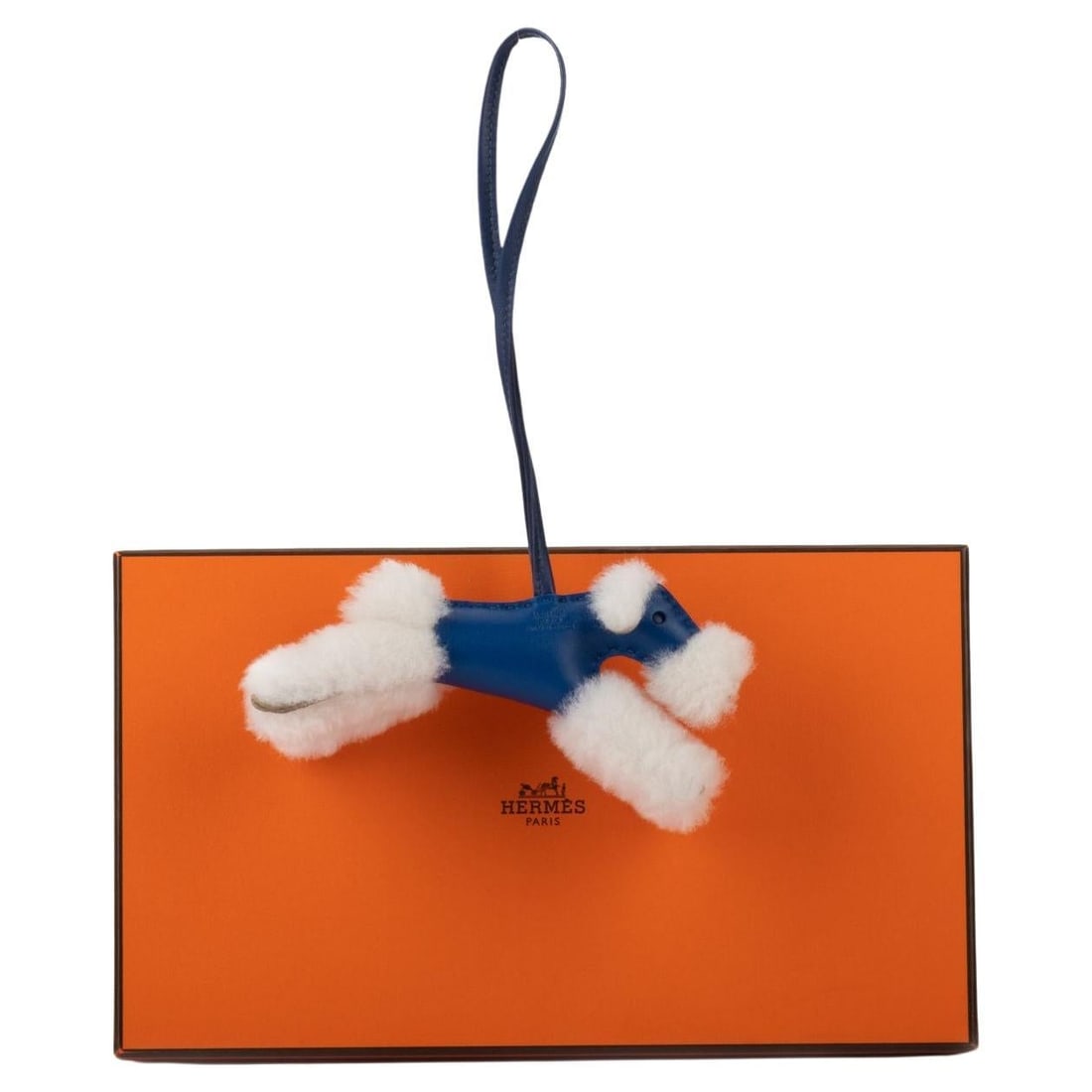 Hermes Blue Shealing Dog Charm BNIB 2022 Electric Blue: Hermes Blue Shealing Dog Charm BNIB 2022 Electric Blue Add a touch of whimsy to your collection with this exquisite Hermes Blue Shealing Dog Charm. Crafted from luxurious electric blue milo leather an