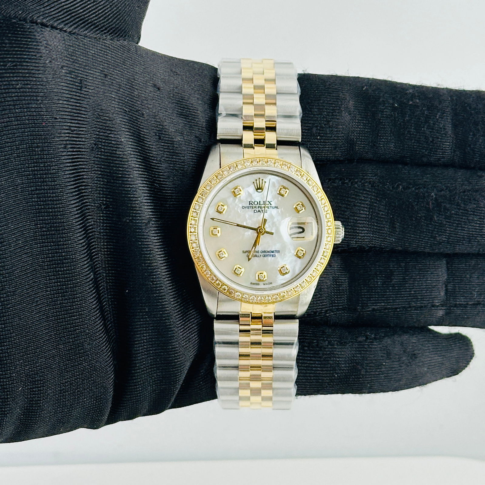 Aftermarket Diamond Dial Oyster Perpetual Date Watch Ref 6694 on Jubilee: Aftermarket Diamond Dial Oyster Perpetual Date Watch Ref 6694 on Jubilee This Rolex Oyster Perpetual Date features an after-market white mother-of-pearl dial adorned with diamond hour markers. The wat