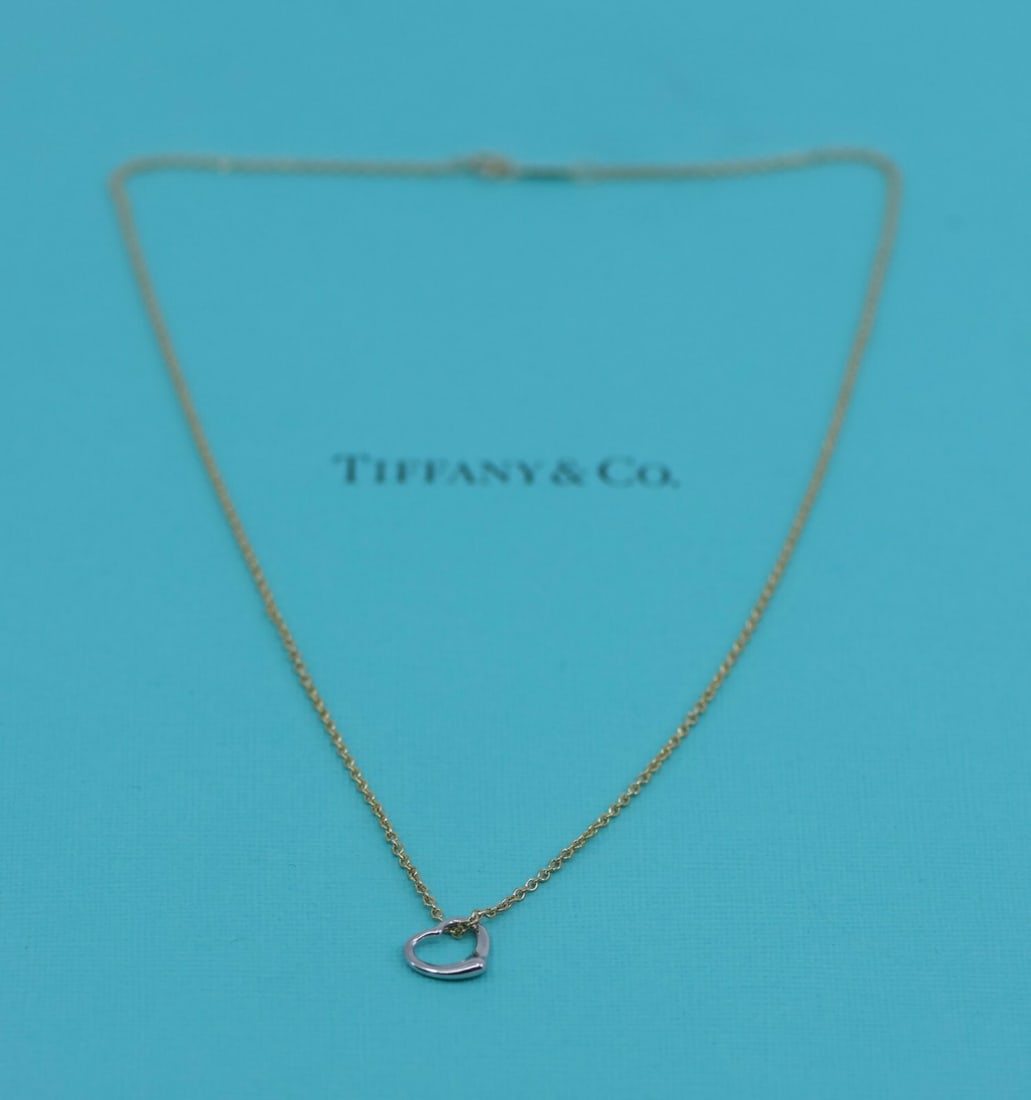 Tiffany & Co Elsa Peretti 18K Yellow Gold Heart Pendant Necklace Authentic: Tiffany & Co Elsa Peretti 18K Yellow Gold Heart Pendant Necklace Authentic Elevate your jewelry collection with this stunning Tiffany & Co. Elsa Peretti pendant necklace. Crafted from a combination of