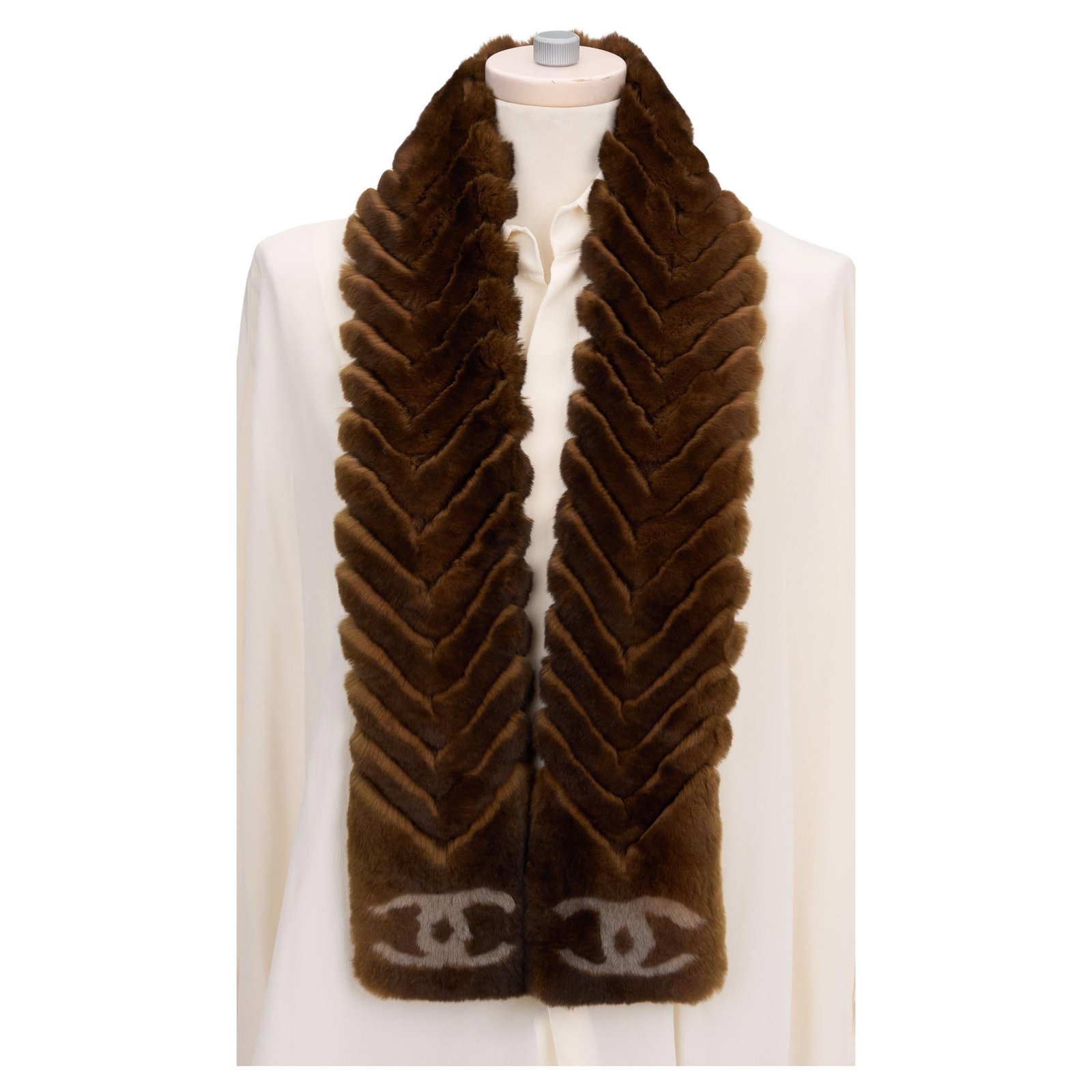Chanel Brown Chinchilla Orylag Scarf with CC Logo: Chanel Brown Chinchilla Orylag Scarf with CC Logo Elevate your winter wardrobe with this exquisite Chanel Chinchilla Orylag scarf. Crafted in Italy, this luxurious scarf boasts a beautiful brown hue a