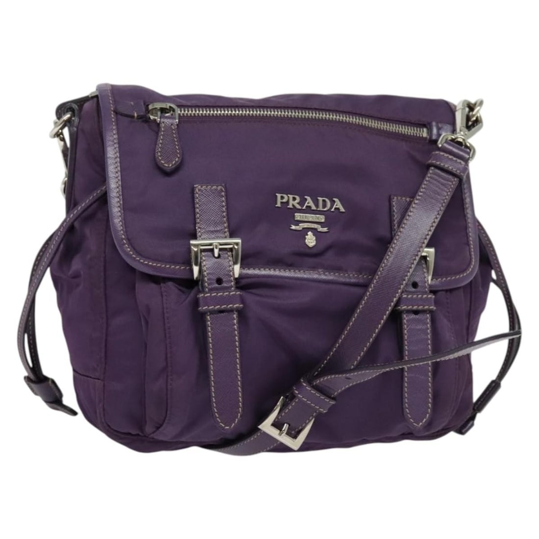 Prada Nylon Camera Bag Purple Double Buckle Flap 21cm by 19cm by 9cm: Prada Nylon Camera Bag Purple Double Buckle Flap 21cm by 19cm by 9cm This pre-owned Prada Double Buckle Flap Camera Bag in purple nylon features a compact design with a flap closure and double buckle