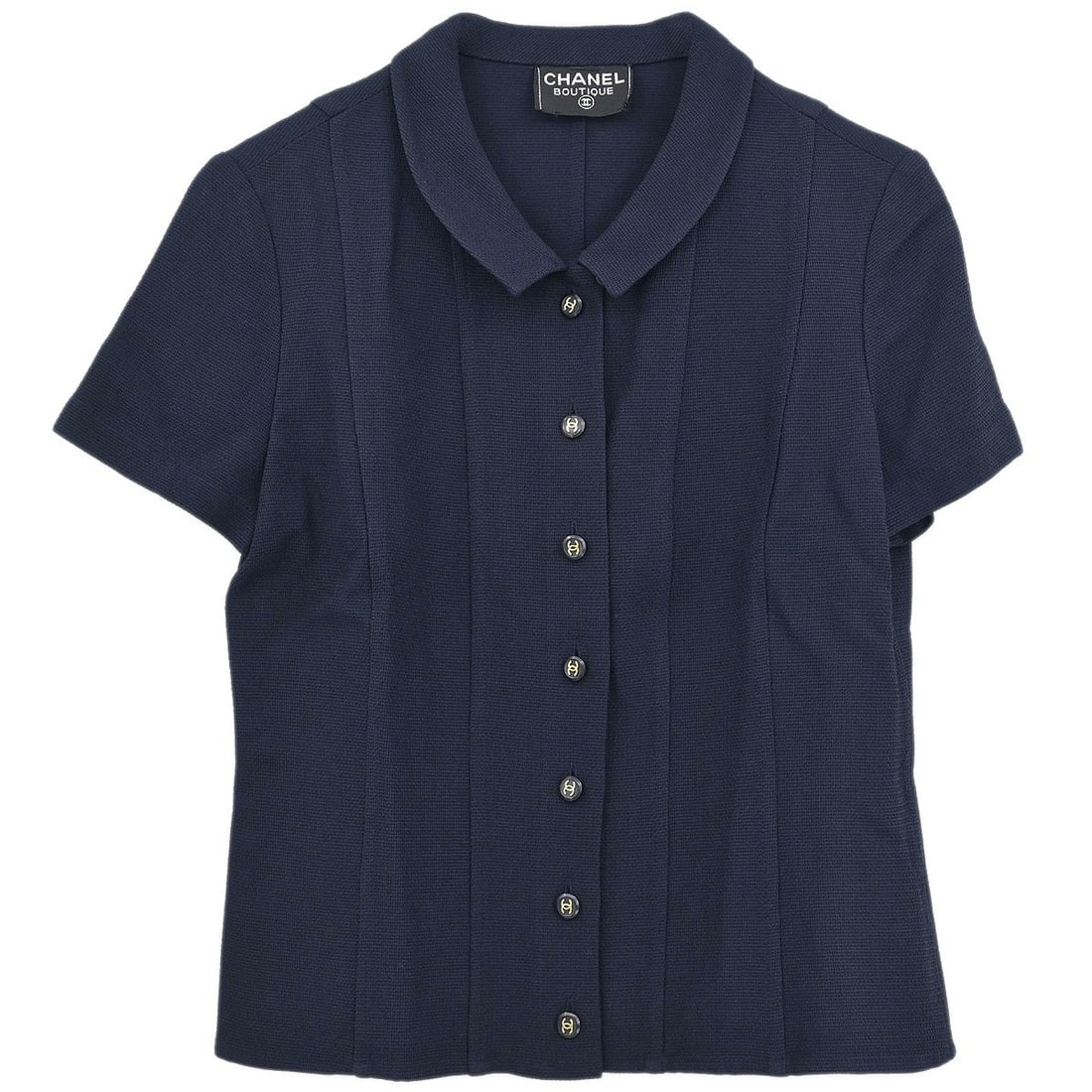 Chanel Vintage Navy Short Sleeve Collared Top: Chanel Vintage Navy Short Sleeve Collared Top Elevate your casual wardrobe with this vintage Chanel short sleeve top in a sophisticated navy hue. Featuring a collared neckline and a regular fit, this