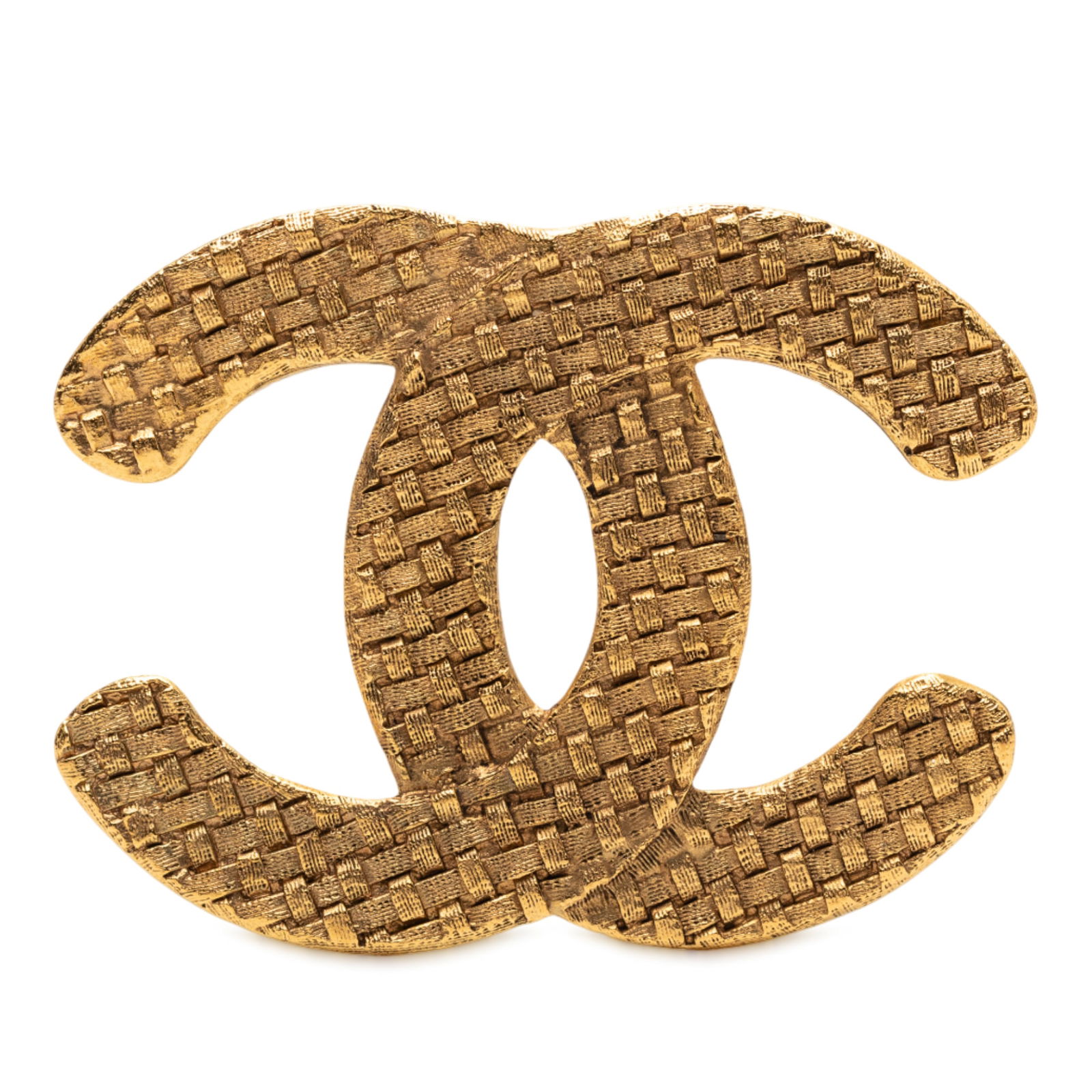Chanel Woven Gold Tone CC Brooch Pin: Chanel Woven Gold Tone CC Brooch Pin This Chanel brooch features a gold-tone metal body with a woven design and a back pin closure. It is a costume jewelry piece originating from France. The exterior