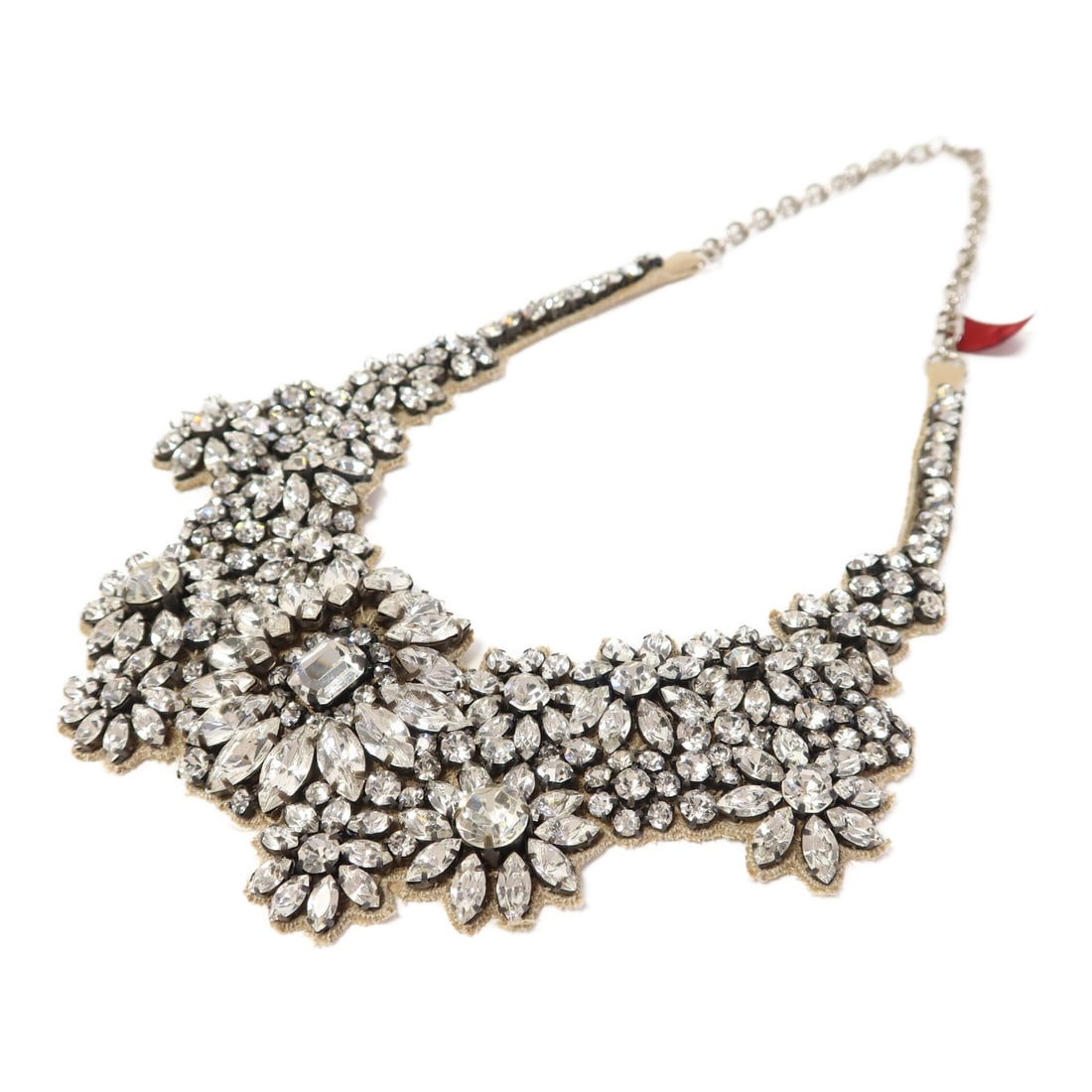 Valentino Clear Silk Necklace with Rhinestone Accents: Valentino Clear Silk Necklace with Rhinestone Accents This exquisite Valentino necklace showcases a unique blend of silk and metal, exuding elegance with its clear color. The design is perfect for add