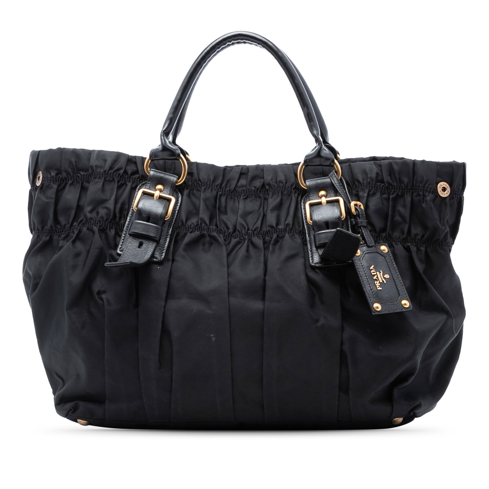 Black Prada Tessuto Gaufre Nylon Tote with Leather Trim: Black Prada Tessuto Gaufre Nylon Tote with Leather Trim This Prada Tessuto Gaufre Tote features a gathered nylon body with leather trim and rolled leather handles. It has an open top with a snap closu