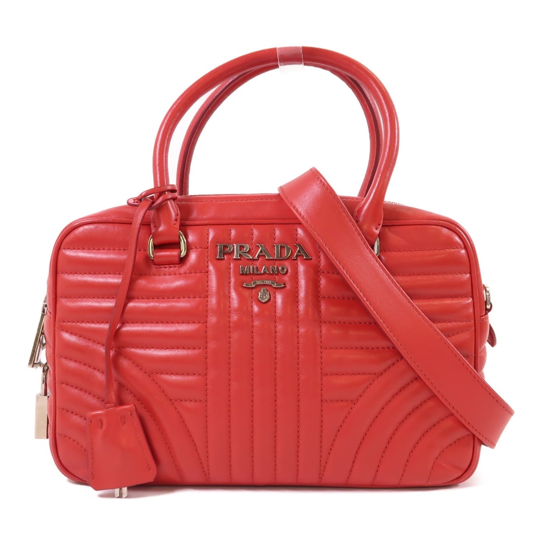 Red Lambskin 2-Way Shoulder Bag by Prada with Silver Hardware: Red Lambskin 2-Way Shoulder Bag by Prada with Silver Hardware This PRADA 2-way shoulder bag is crafted from luxurious lambskin leather in a striking red color. Designed for versatility, it can be carr