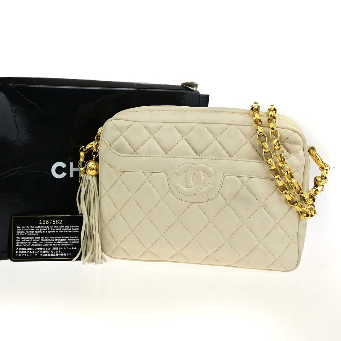 Chanel Chevron Lambskin Vintage Camera Bag with Tassel Ivory Leather: Chanel Chevron Lambskin Vintage Camera Bag with Tassel Ivory Leather This Chanel Vintage Camera Tassel Bag for women features chevron lambskin leather in an ivory color. It is crafted in Italy and des