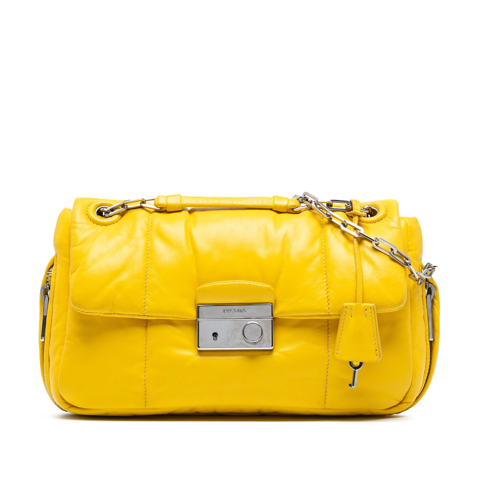 Prada Nappa Bomber Sound Lock Chain Flap Yellow Leather Bag: Prada Nappa Bomber Sound Lock Chain Flap Yellow Leather Bag Introducing the Prada Nappa Bomber Sound Lock Chain Flap, a stylish shoulder bag that combines functionality with luxury. This elegant bag i