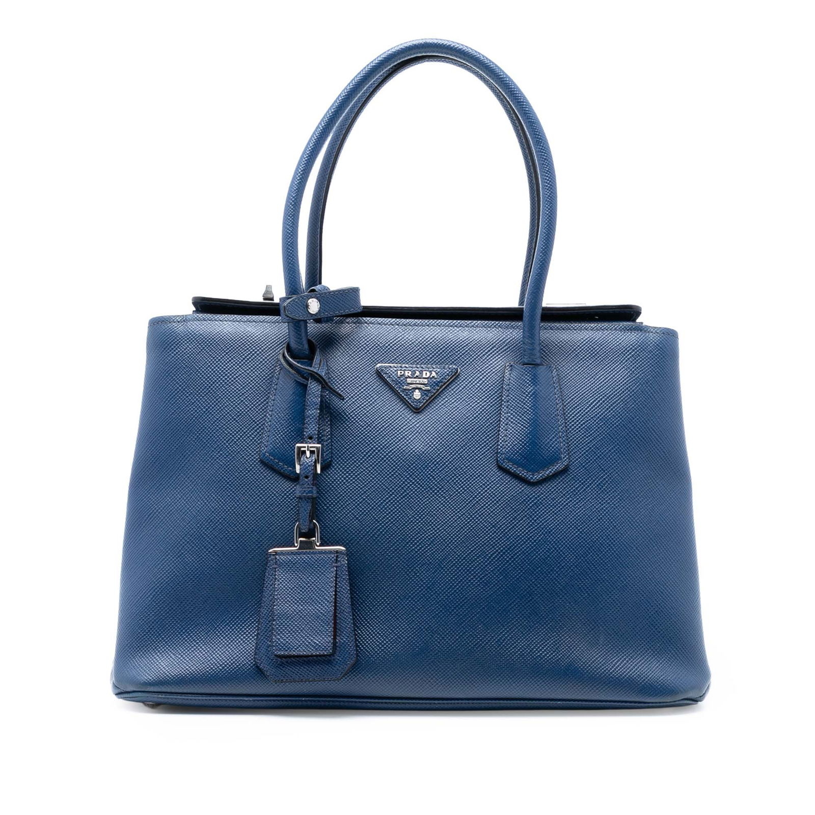 Prada Saffiano Cuir Twin Satchel with Turnlock Closure Blue Leather: Prada Saffiano Cuir Twin Satchel with Turnlock Closure Blue Leather This Prada Saffiano Cuir Turnlock Twin Satchel showcases a blue saffiano leather exterior with rolled leather handles. The bag featu