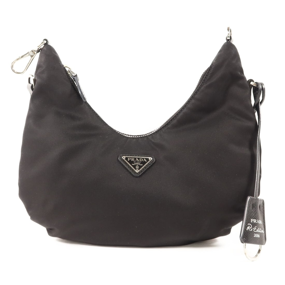 Prada Black Re-Nylon Mini Re-Edition 2006 Handbag with Silver Hardware: Prada Black Re-Nylon Mini Re-Edition 2006 Handbag with Silver Hardware This Prada Re-Edition 2006 mini handbag is crafted from black nylon and features silver-tone hardware. Made in Italy, it offers a