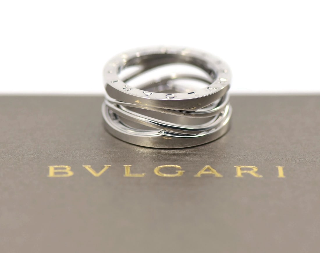 Bulgari B.Zero1 18K White Gold Ring 8.7mm Size 54 Authentic: Bulgari B.Zero1 18K White Gold Ring 8.7mm Size 54 Authentic This exquisite Bulgari B.Zero1 ring is crafted from luxurious 18K white gold, showcasing the elegance of the renowned Bulgari brand. The rin