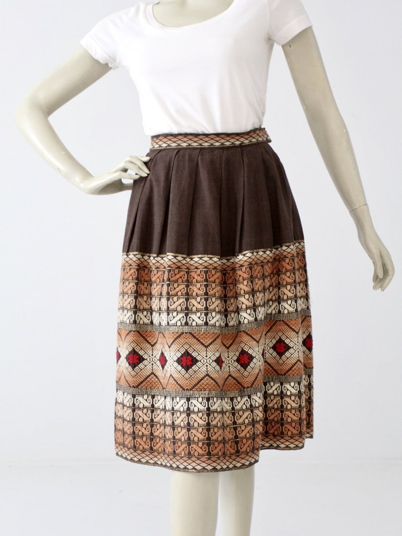 1970s Vintage Southwestern Embroidered Midi Skirt: 1970s Vintage Southwestern Embroidered Midi Skirt Discover a stunning vintage 1970s midi skirt, beautifully crafted from thick dark brown woven cotton. This full skirt features exquisite southwestern