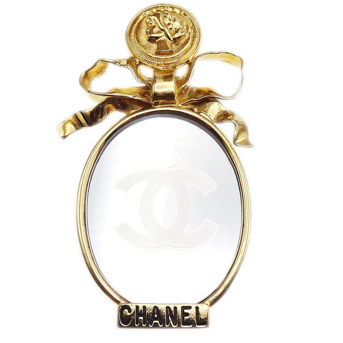 Chanel Gold-Plated Bow Mirror Brooch Pin 4 Inches: Chanel Gold-Plated Bow Mirror Brooch Pin 4 Inches This elegant Chanel Bow Mirror Brooch Pin is a stunning accessory that adds a touch of sophistication to any outfit. Crafted from gold-plated material