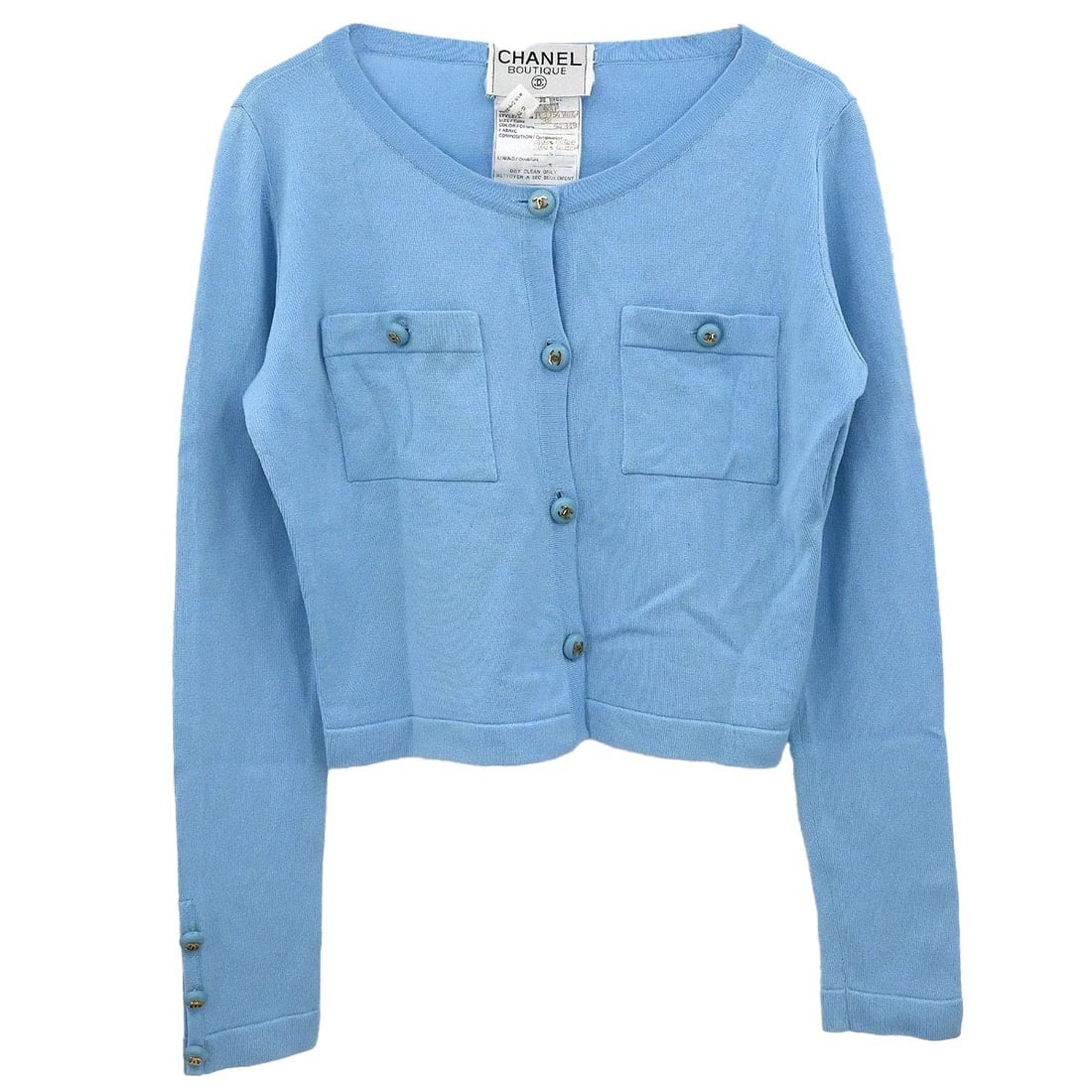 Light Blue Knit Cardigan by Chanel Size 38 100 Percent Cotton: Light Blue Knit Cardigan by Chanel Size 38 100 Percent Cotton This vintage Chanel cardigan features a light blue knit design crafted from 100% cotton. Designed for casual occasions, it offers a regula
