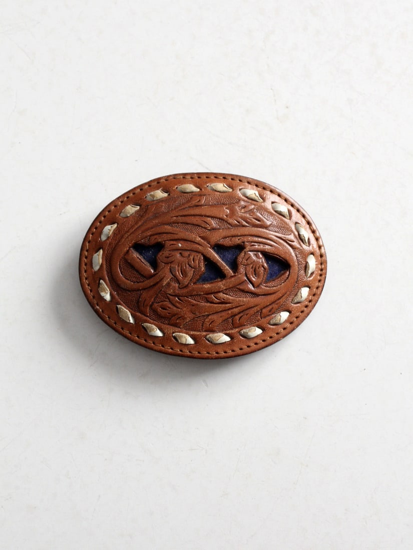 Vintage Tooled Leather Buckle Floral Design Saddle Brown: Vintage Tooled Leather Buckle Floral Design Saddle Brown This vintage tooled leather buckle showcases a beautiful saddle brown finish accentuated by an intricate floral pattern. The buckle features wh