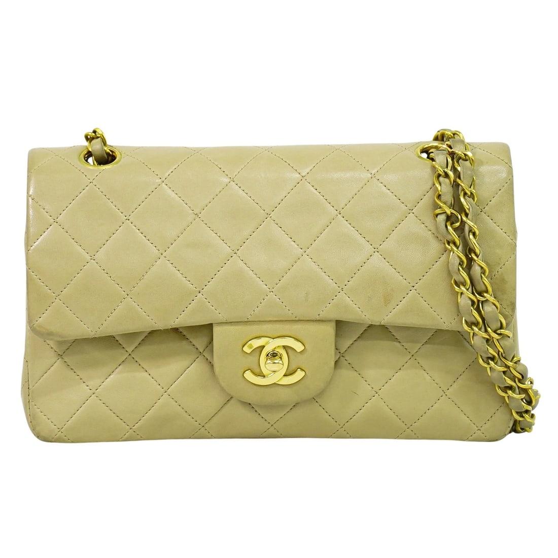 Beige Quilted Leather Double Flap Shoulder Bag by Chanel Timeless: Beige Quilted Leather Double Flap Shoulder Bag by Chanel Timeless This Chanel Timeless Classic Double Flap Bag is crafted from quilted beige lambskin leather and designed for women. It features a doub