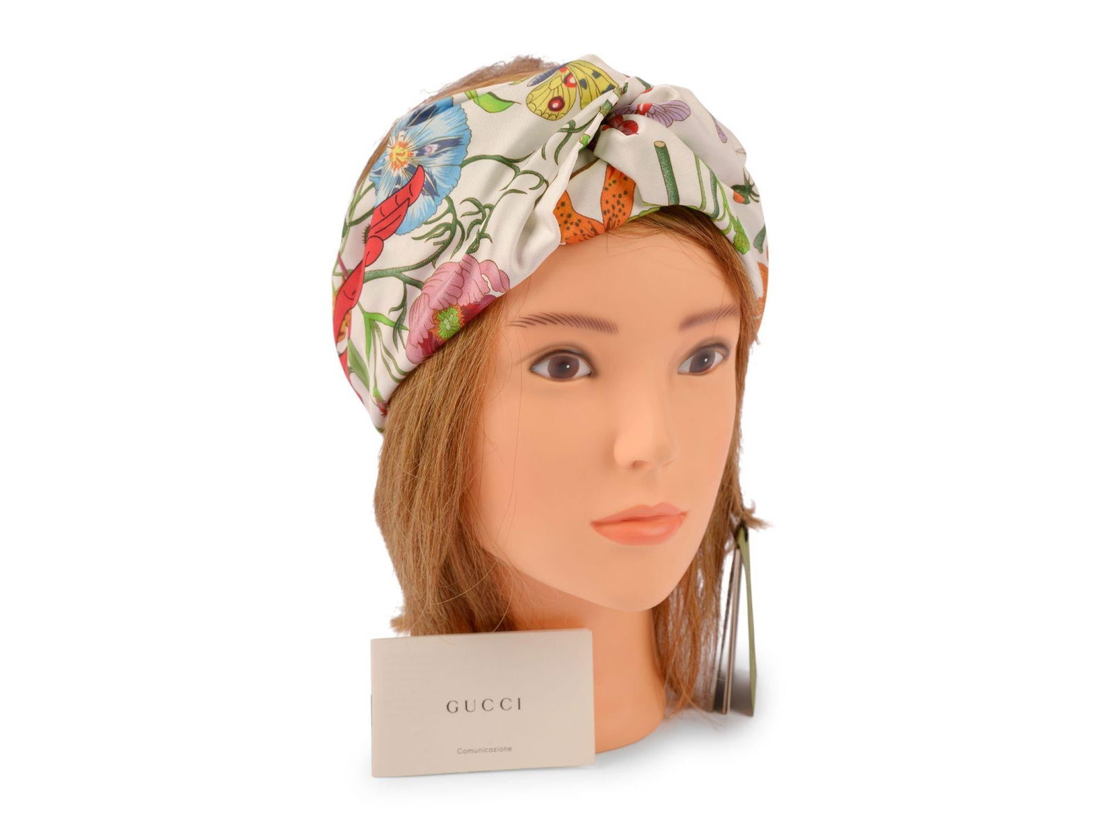 Flora Print Silk Headband by Gucci in White Medium: Flora Print Silk Headband by Gucci in White Medium This Gucci headband is crafted from 100% silk and features a white floral pattern print throughout. It is designed with a twisted detail at the front