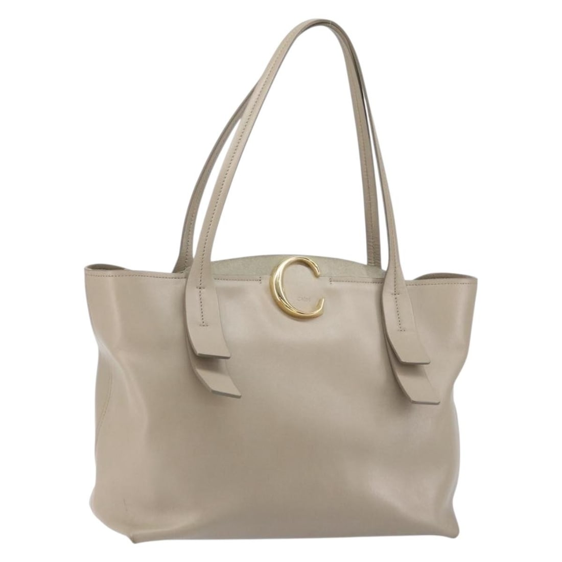 Chloe C Beige Leather Tote Bag Gold Accents Made in Italy: Chloe C Beige Leather Tote Bag Gold Accents Made in Italy This Chloe C tote bag features beige and gold leather with a spacious interior, making it both stylish and practical. Crafted in Italy, the ba