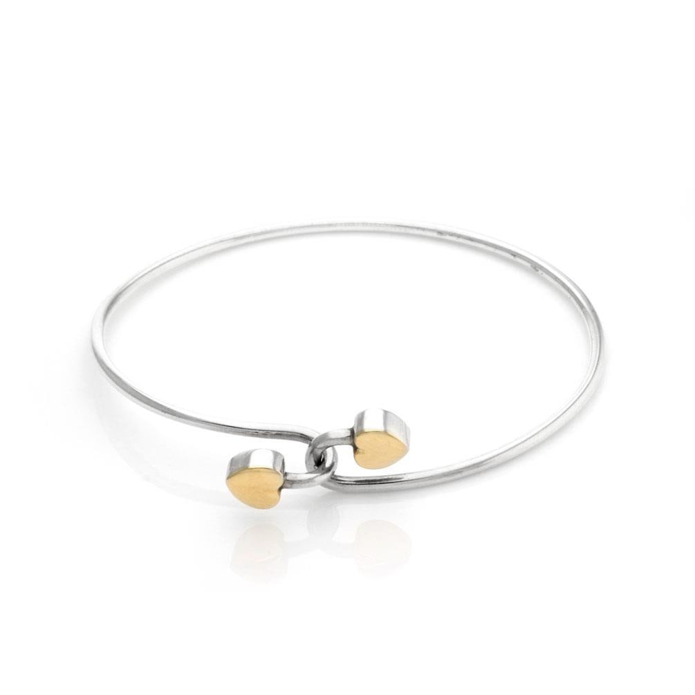 Tiffany & Co. Sterling Silver 18k Yellow Gold Heart Hook Bangle: Tiffany & Co. Sterling Silver 18k Yellow Gold Heart Hook Bangle This exquisite bangle bracelet from Tiffany & Co. showcases a beautiful blend of sterling silver and 18k yellow gold. The design feature