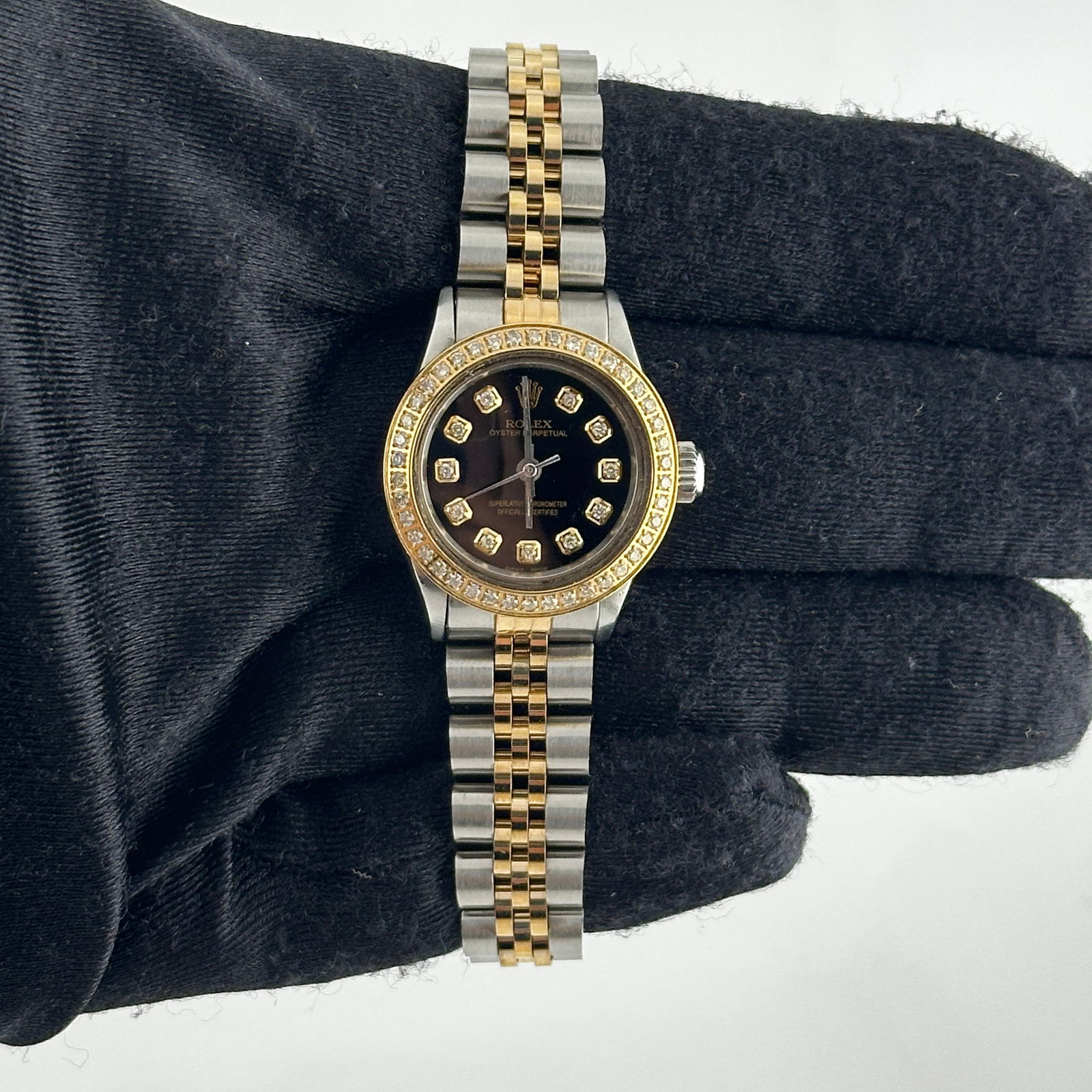 Ladies Aftermarket Black Diamond Oyster Perpetual Watch Ref 6623 Jubilee Band: Ladies Aftermarket Black Diamond Oyster Perpetual Watch Ref 6623 Jubilee Band This ladies' Rolex Oyster Perpetual features an aftermarket black diamond dial, a pave-plated diamond bezel, and an afterm