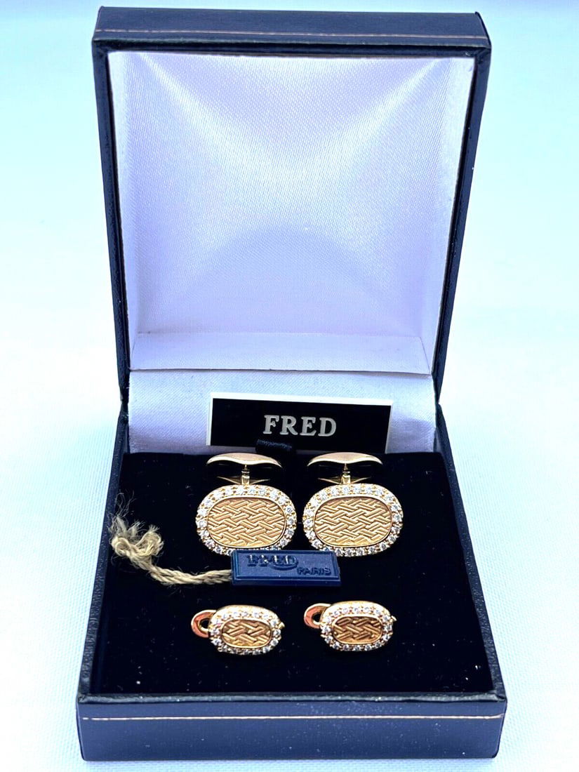 Fred 18K Gold Diamond Cufflinks and Studs Set: Fred 18K Gold Diamond Cufflinks and Studs Set Elevate your formal attire with this exquisite pair of cufflinks and studs by Fred. Crafted from luxurious 18K yellow gold, this set features brilliant wh