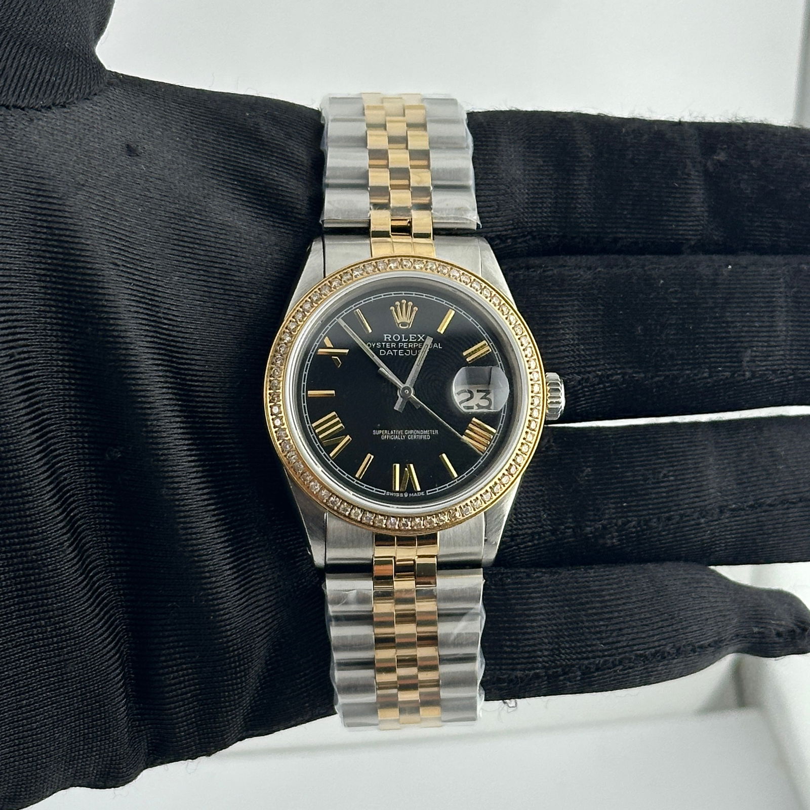 Rolex Datejust 1601 Aftermarket Black Roman Dial Jubilee Watch: Rolex Datejust 1601 Aftermarket Black Roman Dial Jubilee Watch This Rolex Datejust features an aftermarket black dial with Roman stick markers, a pave plated diamond bezel, and an aftermarket Jubilee