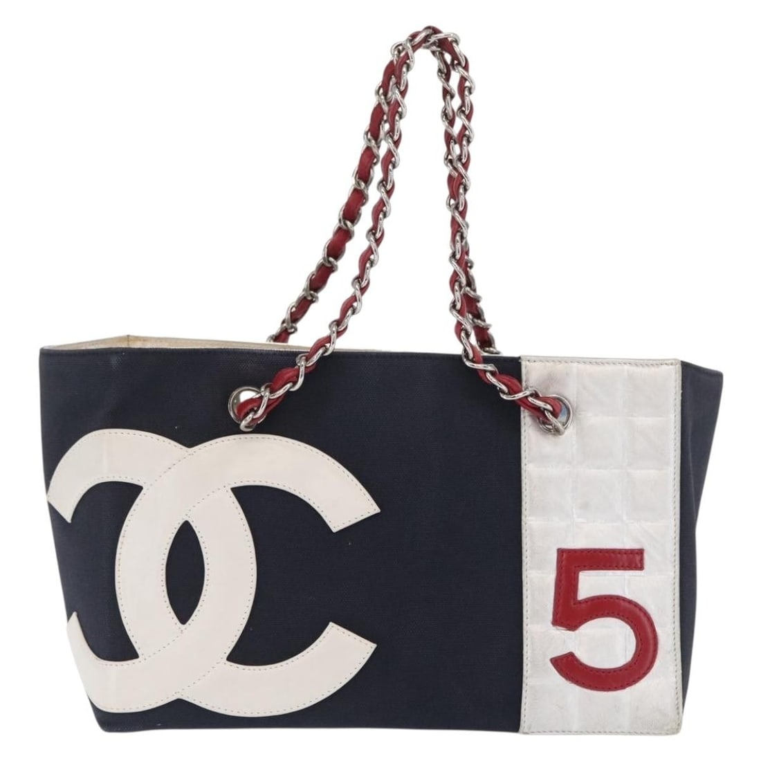 Black Canvas Chanel No.5 Tote Bag with Leather Trim 29cm: Black Canvas Chanel No.5 Tote Bag with Leather Trim 29cm This Chanel No.5 Tote is crafted from black canvas with leather accents, designed for women. The bag features a spacious interior and sturdy ha