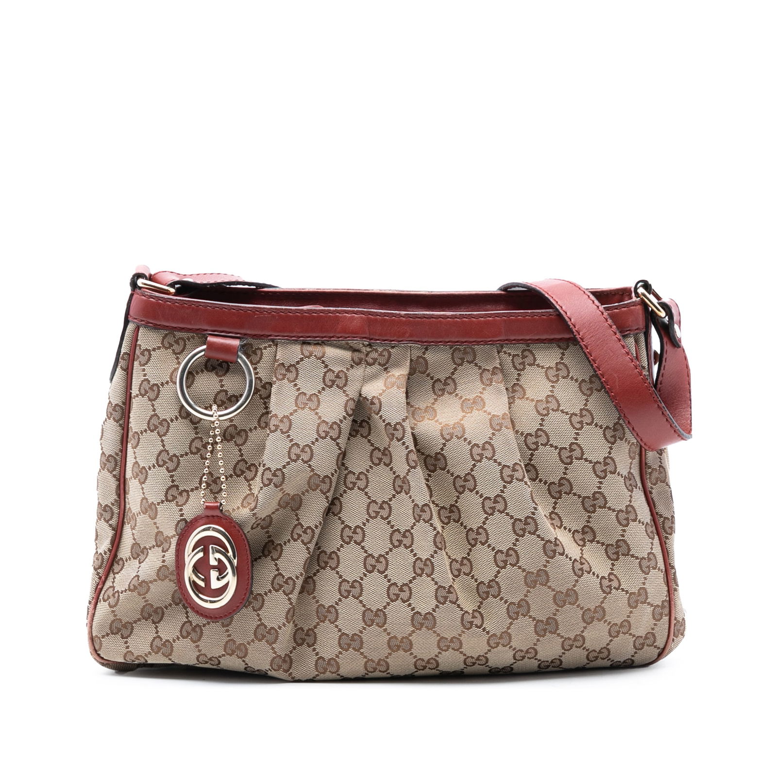 Gucci Sukey Brown GG Canvas Crossbody Bag with Leather Trim: Gucci Sukey Brown GG Canvas Crossbody Bag with Leather Trim The GG Canvas Sukey Crossbody showcases a brown canvas body with leather trim, complemented by a flat leather shoulder strap. It features a