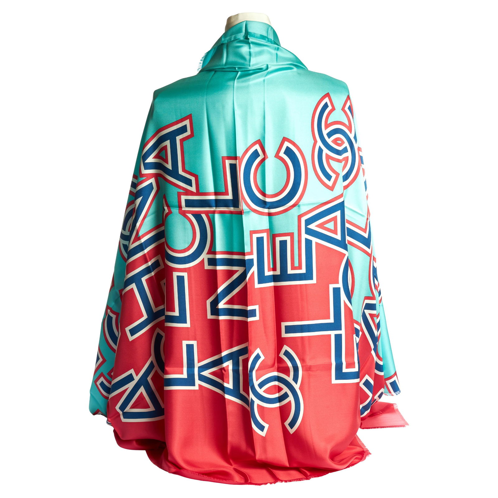 Chanel Oversize Teal Coral Silk Shawl 50 x 74 Italy: Chanel Oversize Teal Coral Silk Shawl 50 x 74 Italy Experience luxury with this Chanel Oversize Shawl, featuring a vibrant teal and coral scrambled letter design. Crafted from 100% silk, this exquisit
