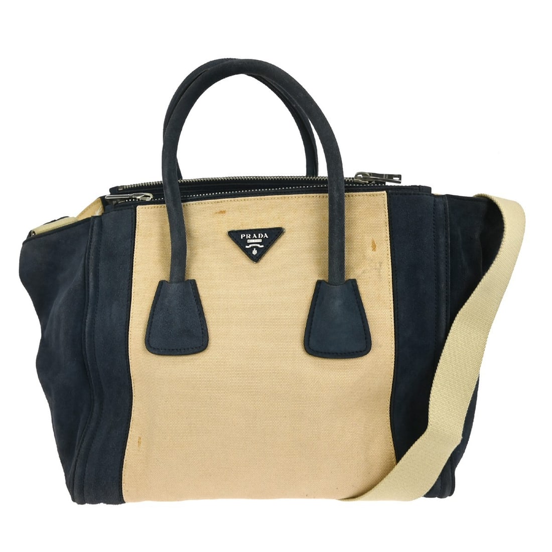 Prada Two Way Canvas Top Handle Bag in Beige and Blue: Prada Two Way Canvas Top Handle Bag in Beige and Blue This stylish Prada 2-way handbag features a chic beige and blue canvas exterior, ideal for casual occasions. The handbag boasts a top handle style
