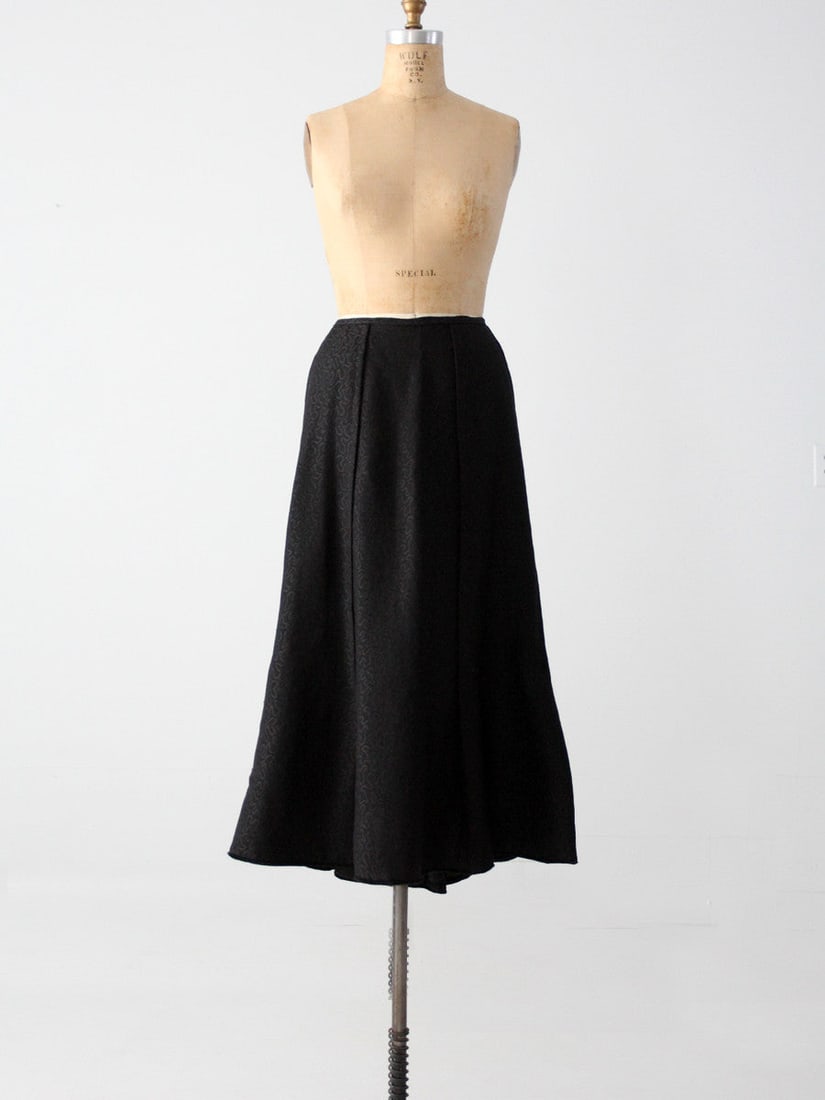 Antique Victorian Wool Carriage Skirt with Pleated Train: Antique Victorian Wool Carriage Skirt with Pleated Train Discover a timeless piece from the Victorian era with this antique wool carriage skirt. This exquisite skirt features a large black fabric ador