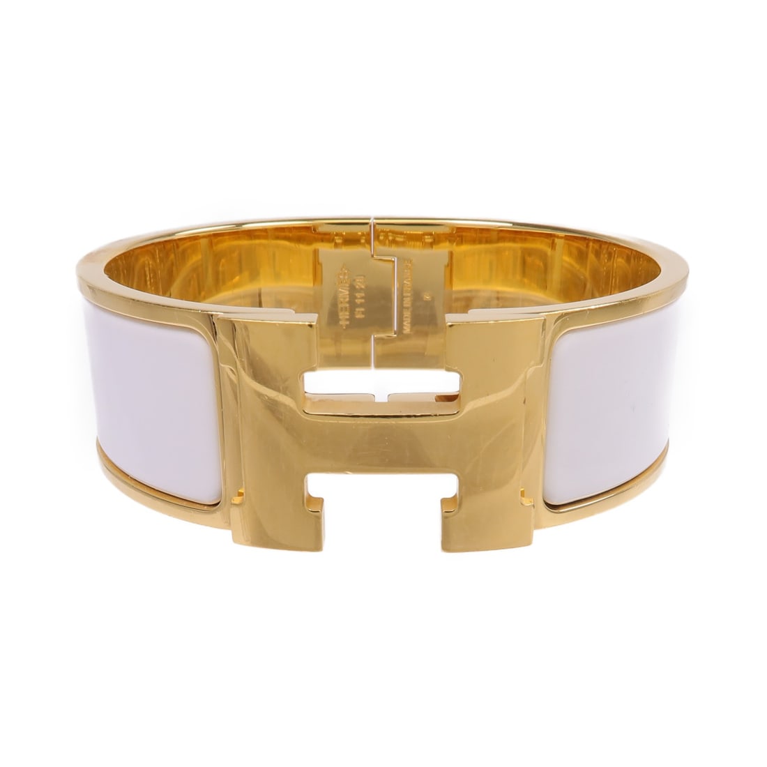 White Enamel and Gold Clic Clac H Bracelet by Hermes: White Enamel and Gold Clic Clac H Bracelet by Hermes This Hermes Clic Clac H bracelet features a sleek white enamel design with metal accents. Made in France, it showcases the iconic H motif and offer