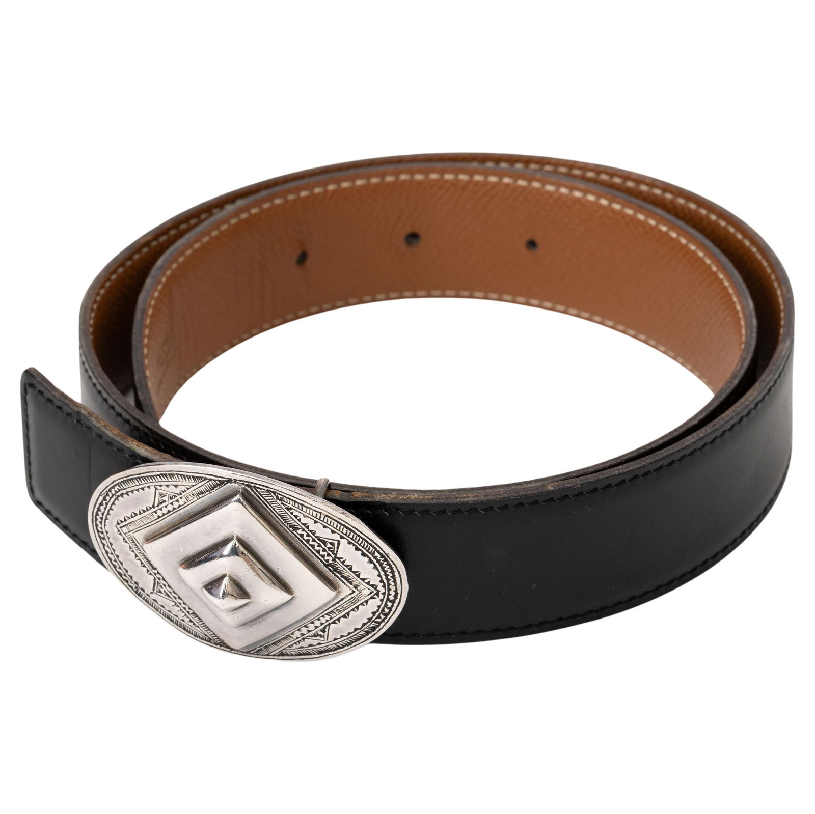 Hermes Limited Edition Reversible Black Gold Belt with Tuareg Buckle: Hermes Limited Edition Reversible Black Gold Belt with Tuareg Buckle This exquisite Hermes Reversible Tuareg Black Gold Belt is a limited edition piece featuring a handmade Tuareg sterling silver buck