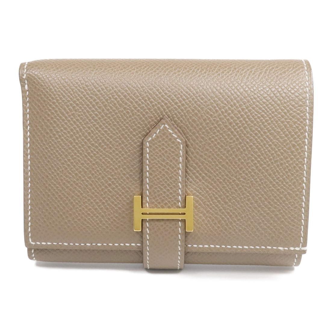 Epsom Leather Bearn Compact Tri-Fold Wallet by Hermes in Gray: Epsom Leather Bearn Compact Tri-Fold Wallet by Hermes in Gray This tri-fold wallet is crafted from Epsom calfskin leather in a gray shade. It features gold-tone hardware and is designed for regular us