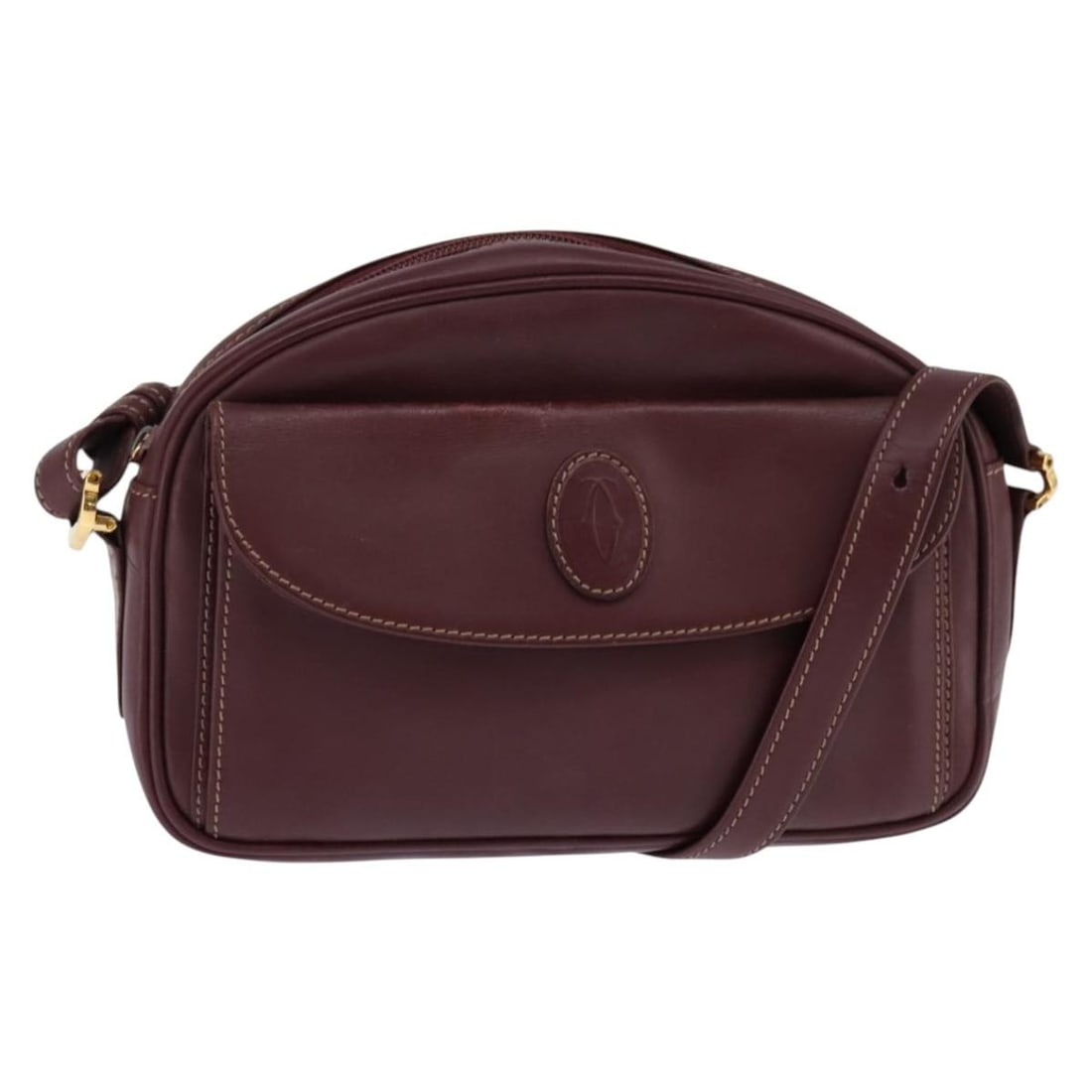 Must de Cartier burgundy leather shoulder bag for women: Must de Cartier burgundy leather shoulder bag for women The Must de Cartier Shoulder Bag is crafted from burgundy leather and designed for women. This pre-owned bag features a spacious main compartmen