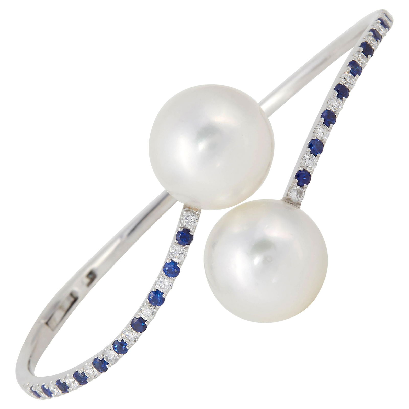 18K White Gold South Sea Pearl Diamond Sapphire Bypass Bracelet 1.10 Carat: 18K White Gold South Sea Pearl Diamond Sapphire Bypass Bracelet 1.10 Carat This stunning contemporary bypass bangle bracelet is crafted from 18K white gold and features exquisite South Sea pearls, eac