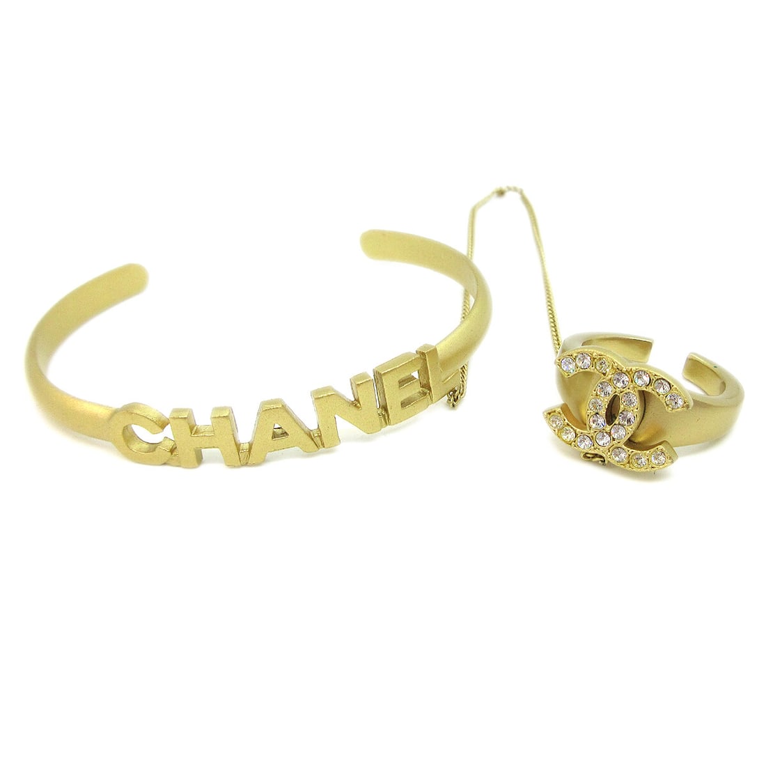 Chanel Gold Plated Rhinestone Bangle Chain Ring 5.9 in: Chanel Gold Plated Rhinestone Bangle Chain Ring 5.9 in This stunning Chanel bangle chain ring is a luxurious accessory that combines elegance with a modern design. Crafted from gold-plated material, t