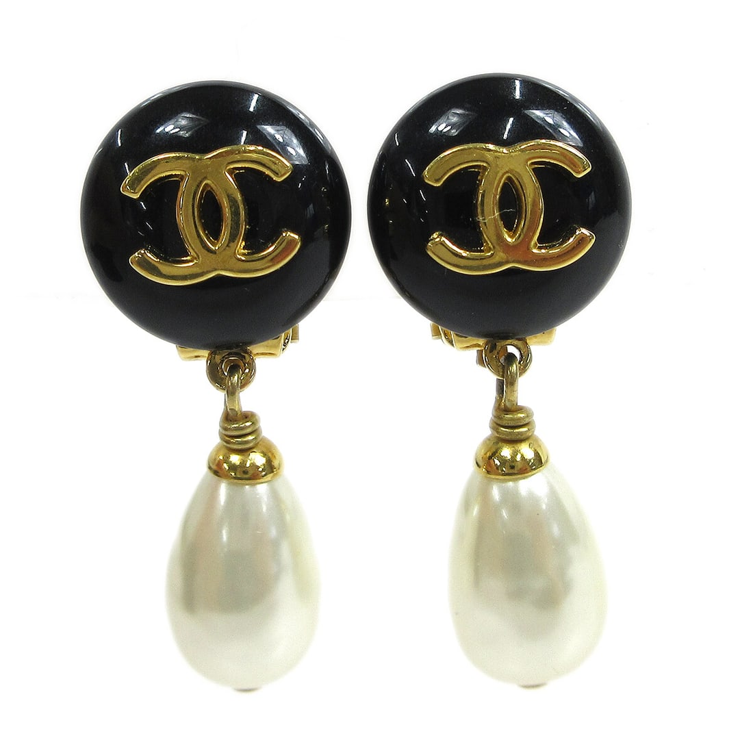 Chanel Black Button Clip-On Earrings with Artificial Pearls 97A: Chanel Black Button Clip-On Earrings with Artificial Pearls 97A Elevate your accessory collection with these stunning Chanel Clip-On Earrings. Crafted in a chic black color, these earrings feature a s