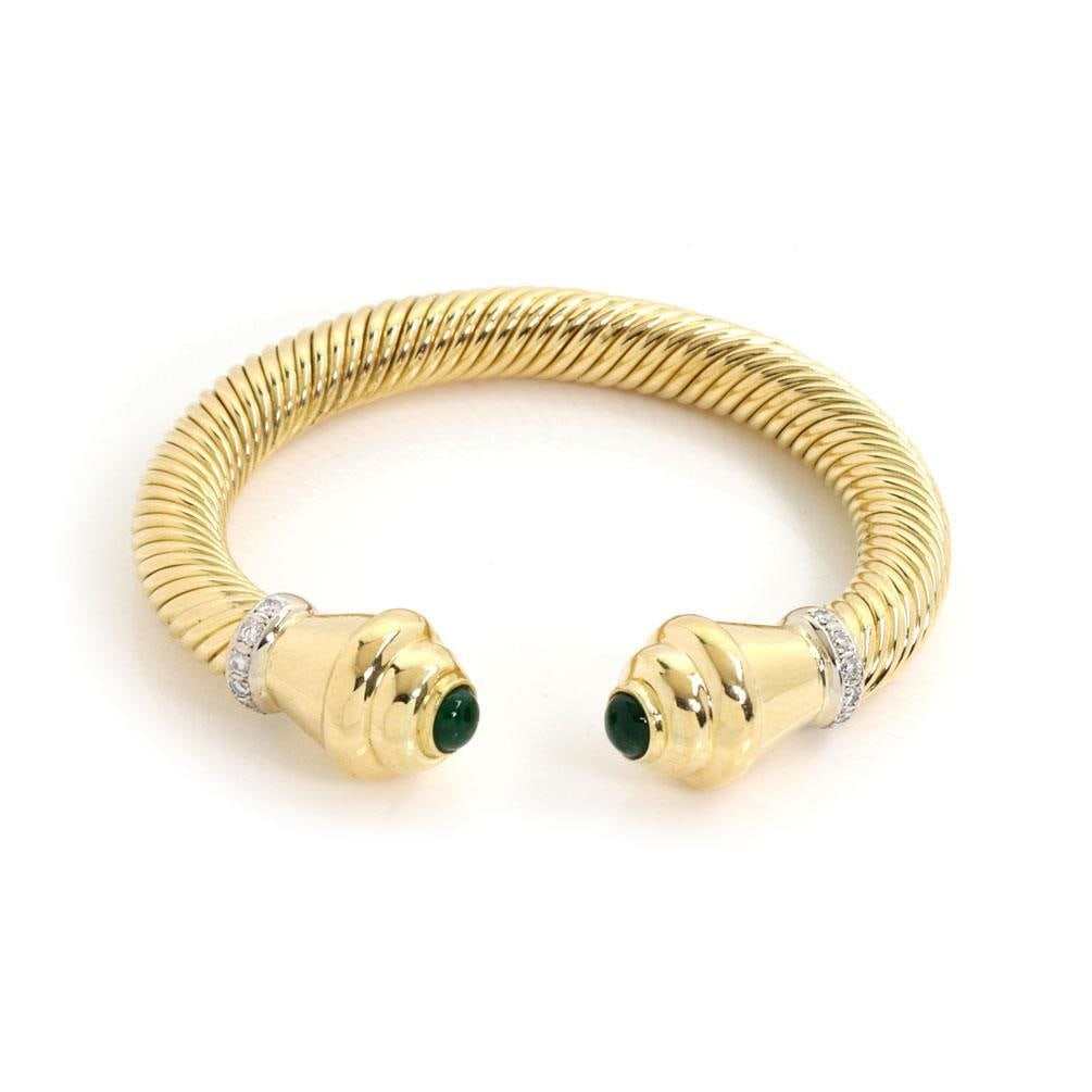 Elegant 18k Yellow Gold Flex Cuff Bracelet with Diamonds and Emeralds: Elegant 18k Yellow Gold Flex Cuff Bracelet with Diamonds and Emeralds This exquisite flex cuff bracelet is crafted from 18k yellow gold featuring a polished finish. It showcases a unique stretch flex