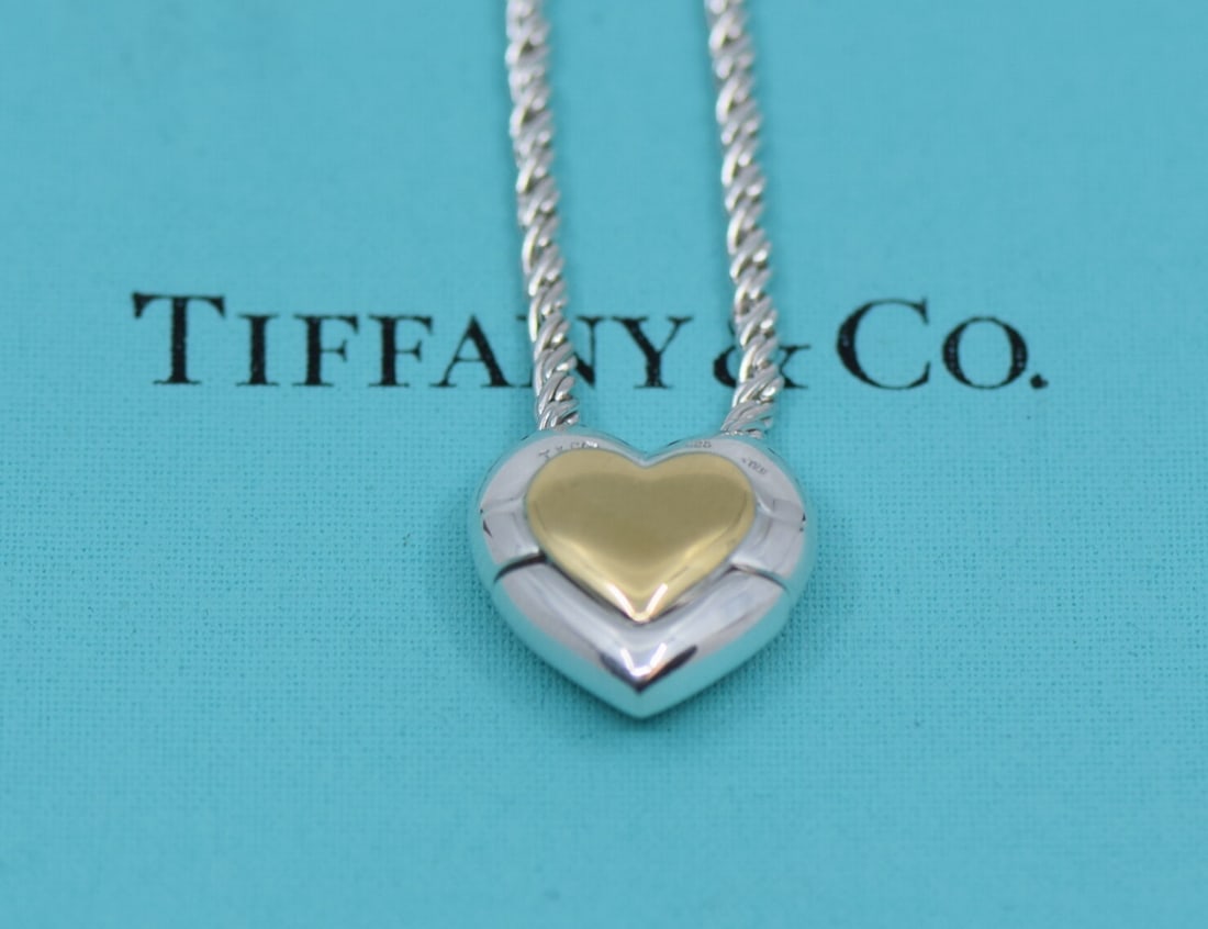 Tiffany & Co Heart Pendant Necklace 18K Sterling Silver Authentic: Tiffany & Co Heart Pendant Necklace 18K Sterling Silver Authentic This exquisite heart pendant necklace from Tiffany & Co is crafted from a combination of 18K gold and sterling silver. The pendant is