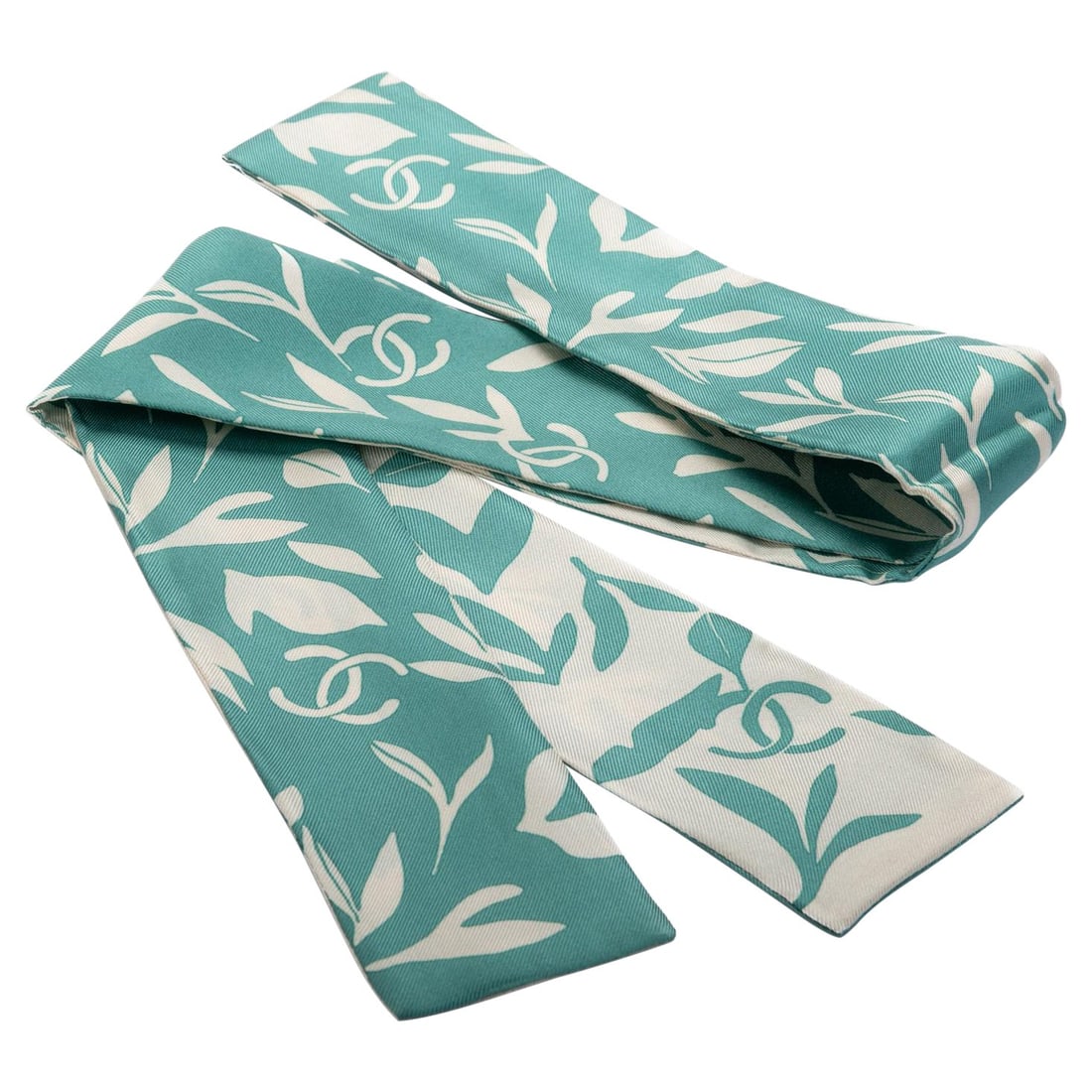 Chanel 100% Silk Twilly Scarf Green White Leaves Design 48in: Chanel 100% Silk Twilly Scarf Green White Leaves Design 48in Elevate your style with this exquisite Chanel Silk Twilly scarf, featuring a captivating logo and leaves design. Crafted from 100% silk, th