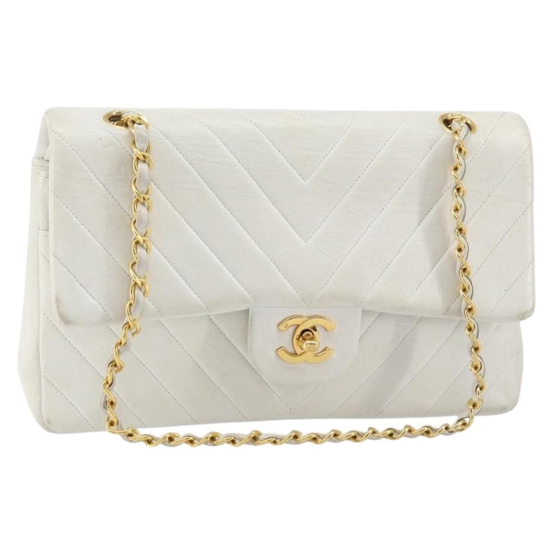 White Lambskin Chevron Double Flap Vintage Shoulder Bag by Chanel: White Lambskin Chevron Double Flap Vintage Shoulder Bag by Chanel This Chanel Vintage Classic Double Flap Bag features a chevron V-stitch design crafted from white leather. The bag is designed for wom