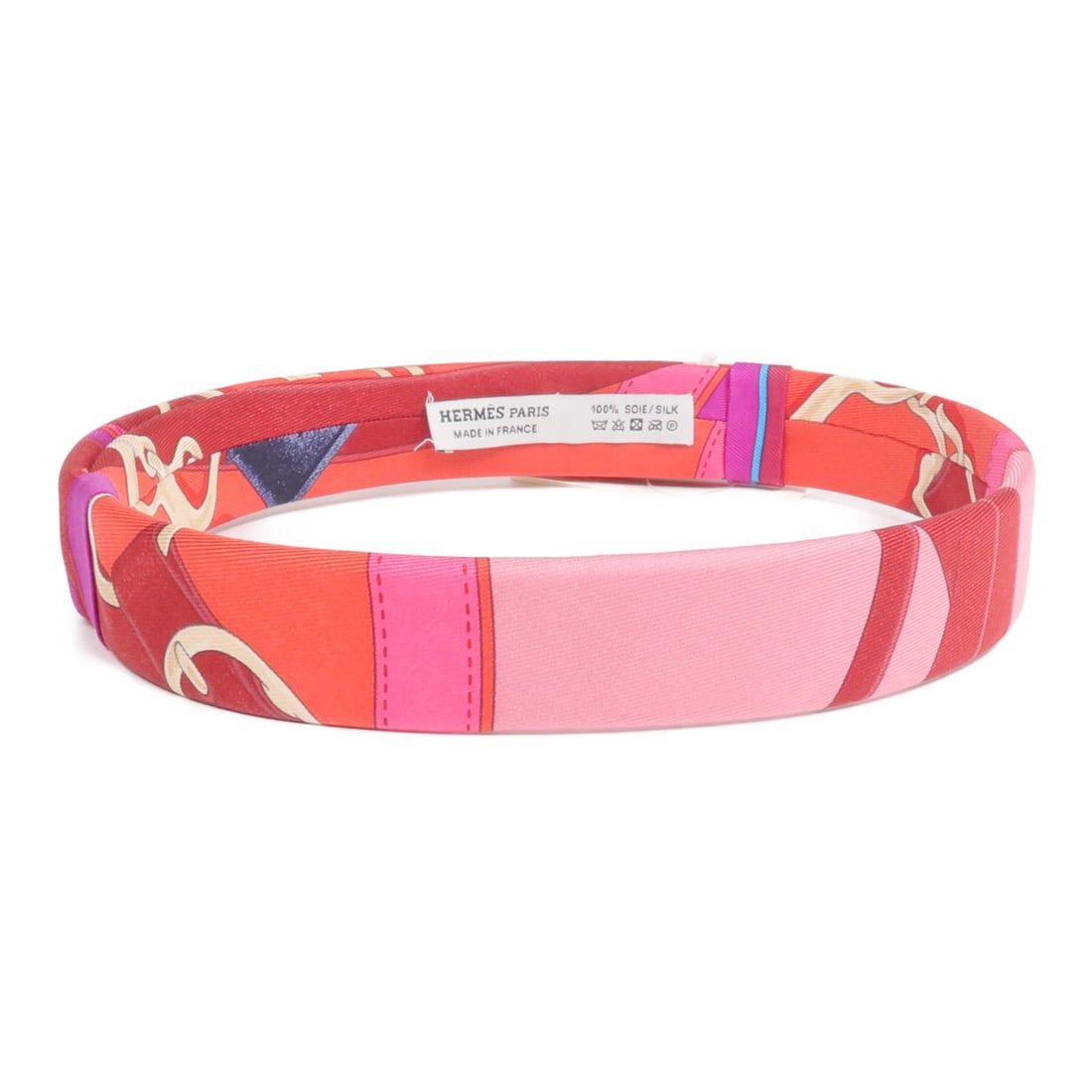 Silk Red and Pink Hair Accessory by Hermes: Silk Red and Pink Hair Accessory by Hermes This is a Hermes hair band crafted from high-quality silk in a vibrant red and pink color scheme. Made in France, it features a stylish design suitable for v