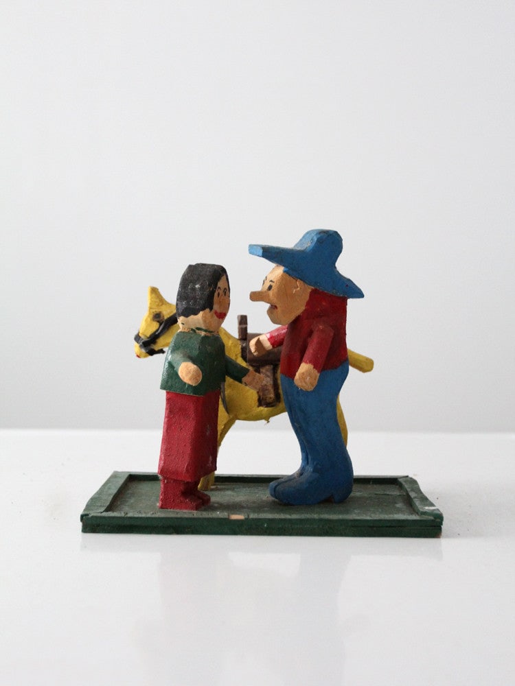 Handcrafted Vintage Folk Art Cowboy Figure with Lady and Horse: Handcrafted Vintage Folk Art Cowboy Figure with Lady and Horse Enhance your home decor with this charming vintage folk art cowboy scene. This handcrafted wood cowboy figure is depicted with his two lo