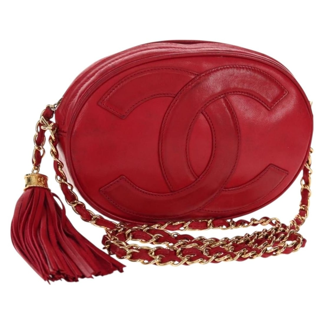 Red Leather Crossbody Bag with Tassel by Chanel Vintage Oval CC: Red Leather Crossbody Bag with Tassel by Chanel Vintage Oval CC This Chanel Vintage Oval CC Tassel Crossbody Bag is crafted from red leather with a distinctive oval shape and signature CC tassel detai