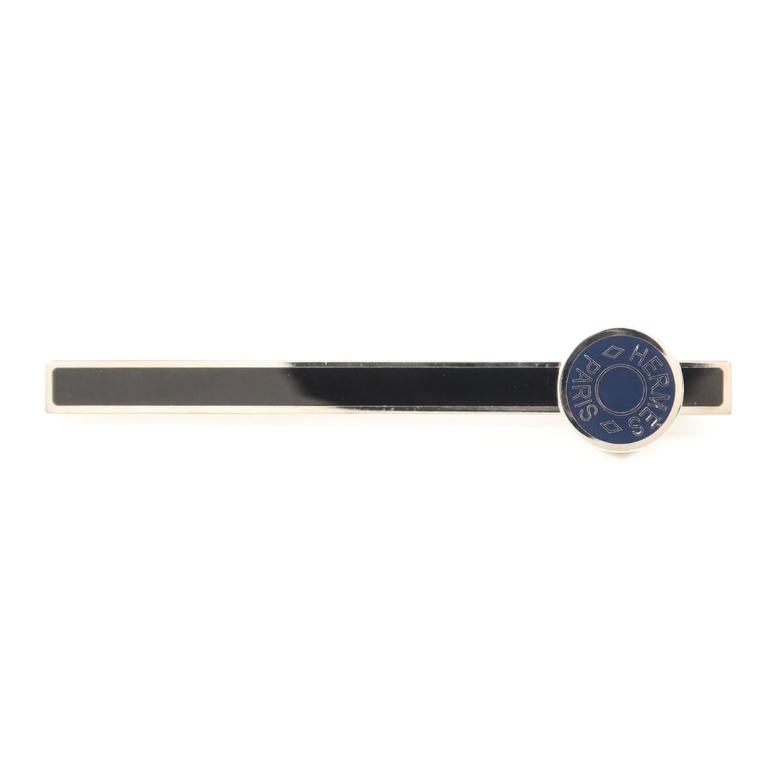 Navy and Black Metal Tie Bar by Hermes France: Navy and Black Metal Tie Bar by Hermes France This Hermes tie clip features a navy blue and black color scheme and is crafted from metal. Made in France, it is designed to add a touch of sophisticatio