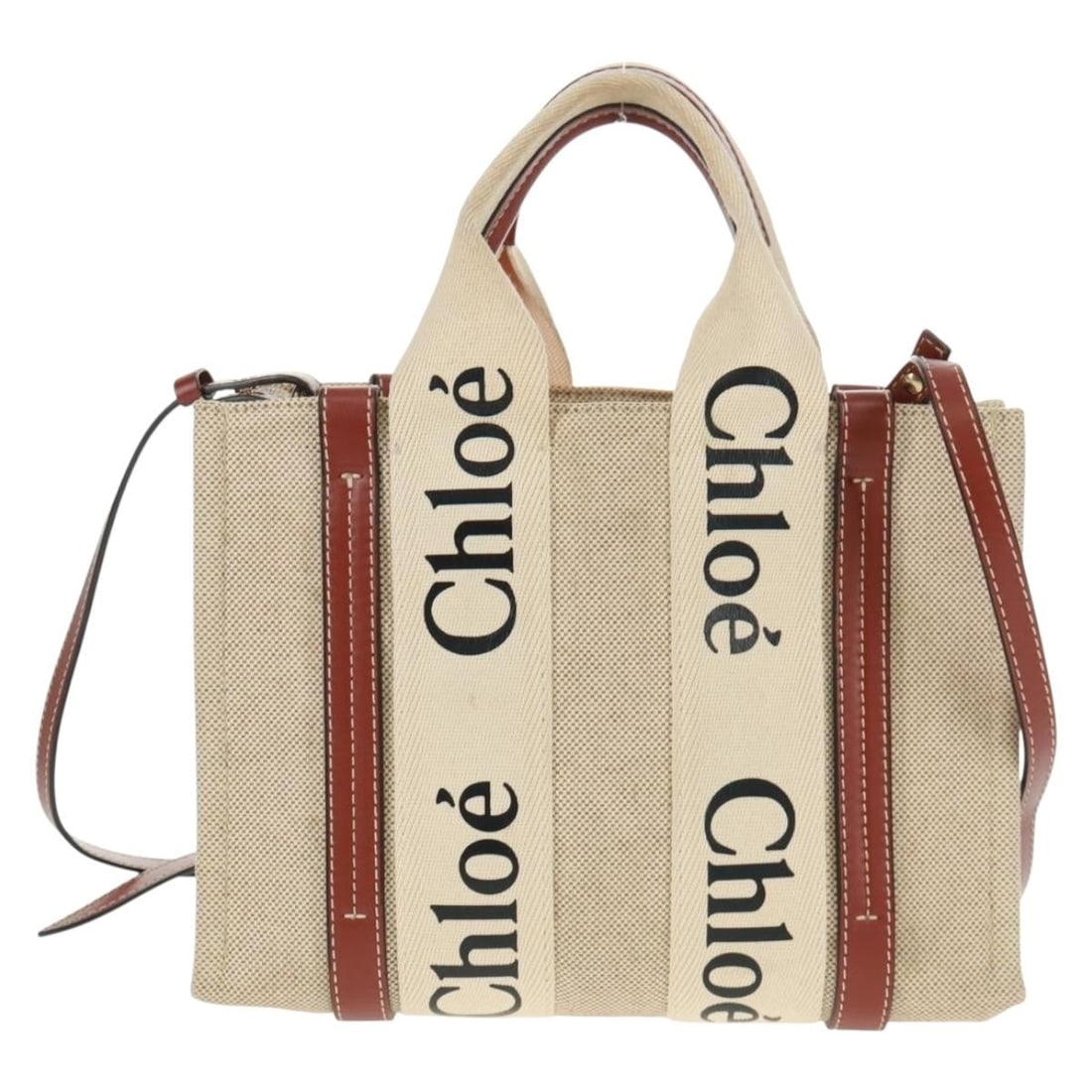 Beige Canvas Woody Tote by Chloe with Leather Accents: Beige Canvas Woody Tote by Chloe with Leather Accents The Chloe Woody Convertible Tote is crafted from beige canvas with leather accents, designed for women. This tote features both handles and a shou