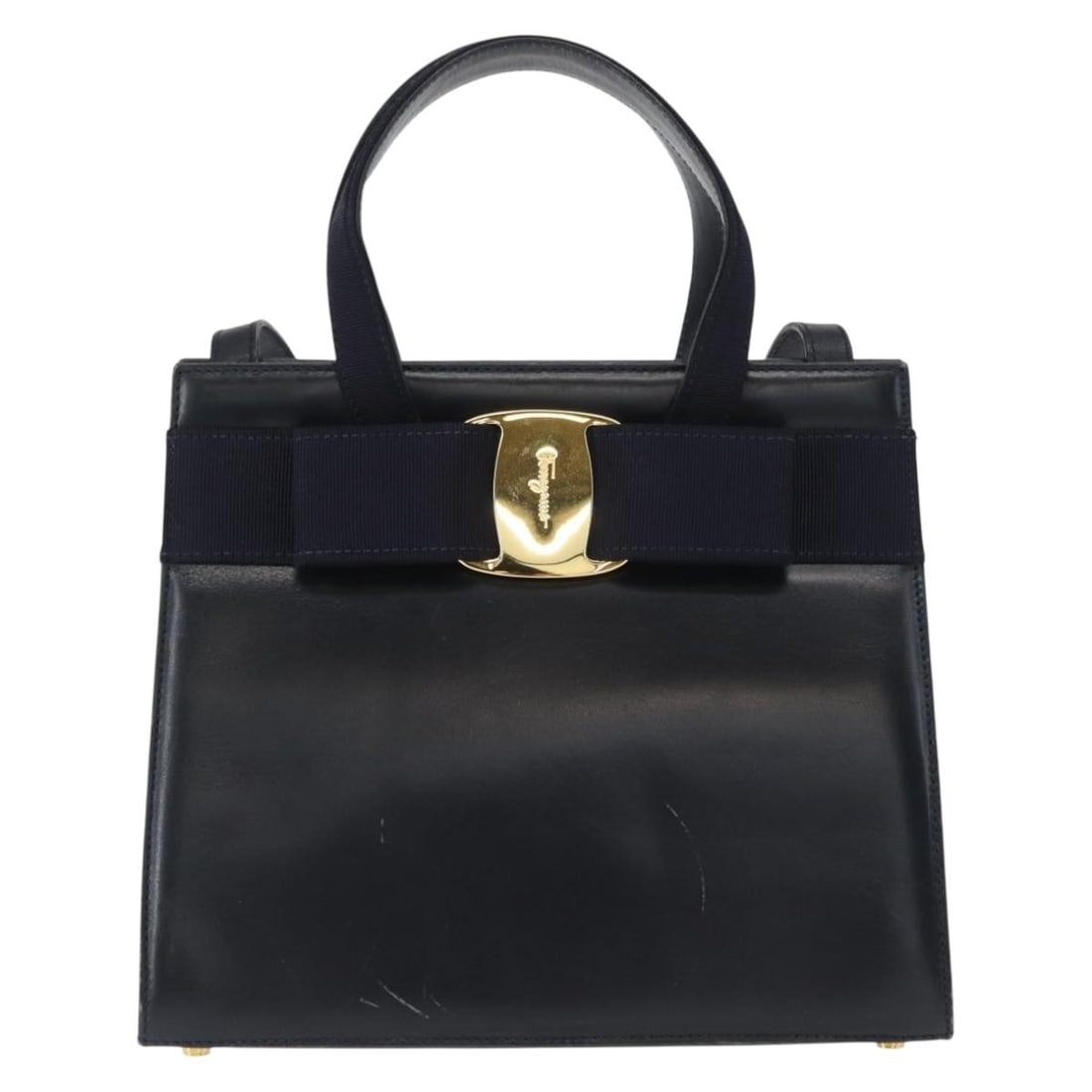Navy Leather Convertible Vara Bow Tote by Salvatore Ferragamo: Navy Leather Convertible Vara Bow Tote by Salvatore Ferragamo This Salvatore Ferragamo Convertible Vara Bow Tote is crafted from navy leather and designed for women. It features a structured silhouett