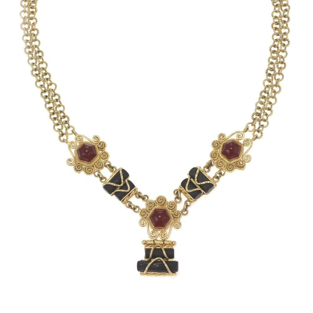 Estate 18k Yellow Gold Ruby Onyx Floral Pendant Necklace: Estate 18k Yellow Gold Ruby Onyx Floral Pendant Necklace This exquisite estate necklace is crafted from 18k yellow gold and features a stunning floral centerpiece. The centerpiece showcases three flow