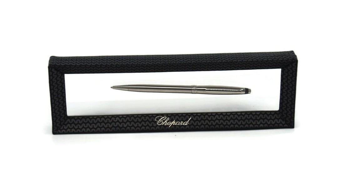 Metal Ballpoint Writing Pen by Chopard with Black Ink: Metal Ballpoint Writing Pen by Chopard with Black Ink This Chopard ballpoint pen features a durable metal construction and is designed for smooth black ink writing. Crafted in Switzerland, it showcase
